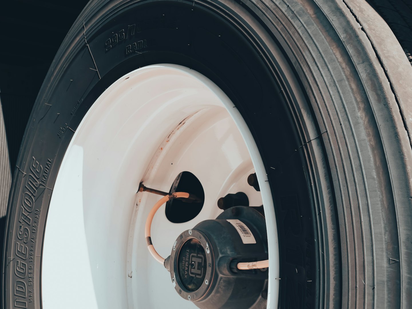 Close up of a truck tire and white steel wheel.